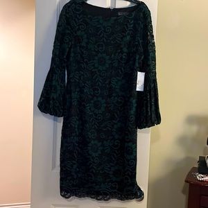 Green lace overlay dress with sheer lace sleeves.